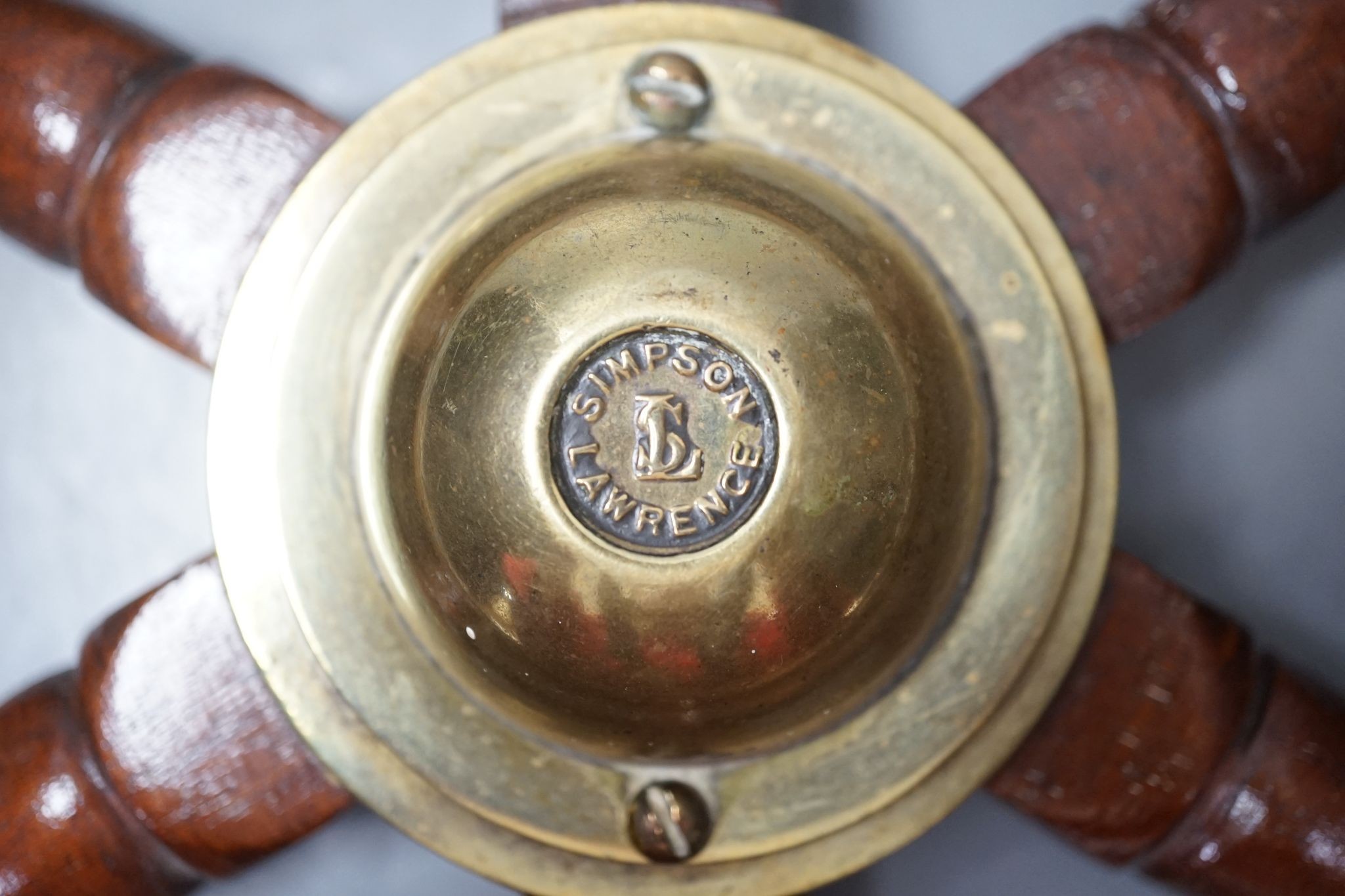 A teak and brass mounted Ship's wheel signed Lawrence Simpson 47cm